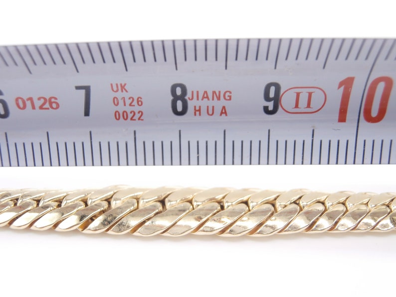 May include: A gold chain necklace measuring 9 inches in length. The chain is made of a twisted design.