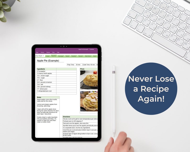 Peut inclure: Une tablette num&eacute;rique affichant une recette de tarte aux pommes. La recette comprend les ingr&eacute;dients, des notes, des instructions et des photos. Le texte &agrave; l'&eacute;cran indique "Apple Pie (Example)". La tablette est sur une surface blanche avec un clavier blanc et un stylet.