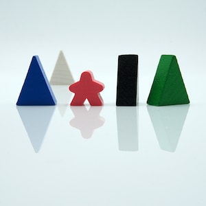 May include: Five wooden game pieces in different shapes and colors. A blue triangle, a white triangle, a red star-shaped piece, a black rectangle, and a green triangle.