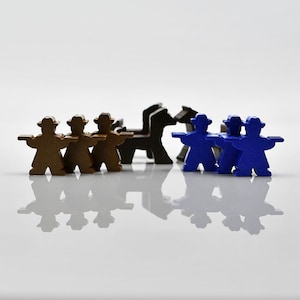 May include: A group of wooden game pieces, three brown and four blue, standing in a row. The brown pieces are wearing hats and have arms outstretched. The blue pieces are also wearing hats and have arms outstretched. There are two brown horses in the middle of the row.