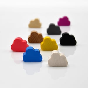 May include: A set of nine cloud-shaped wooden game pieces in various colours, including red, yellow, blue, black, white and brown.