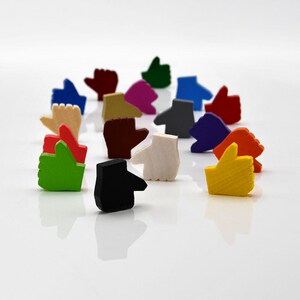 May include: A collection of colorful wooden thumbs up hand gestures. The thumbs are in various colors, including red, green, yellow, blue, black, white, and orange.