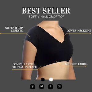 May include: Black crop top with a V-neck and short sleeves. The top has a lower neckline and a comfy elastic band to stay in place. The text "BEST SELLER" and "SOFT V-Neck CROP TOP" is displayed above the image. The text "NO SEAM CAP SLEEVES" is displayed on the left side of the image. The text "LOWER NECKLINE" is displayed on the right side of the image. The text "COMFY ELASTIC TO STAY IN PLACE" is displayed on the left side of the image. The text "SOFTEST FABRIC" is displayed on the right side of the image. The text "S M L XL" is displayed below the image.