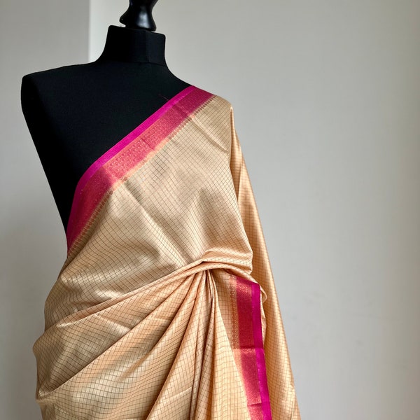 Off white and magenta crepe binny silk saree with  contrast border, pallu and blouse. Beautiful magenta gives a stylish twist to this saree