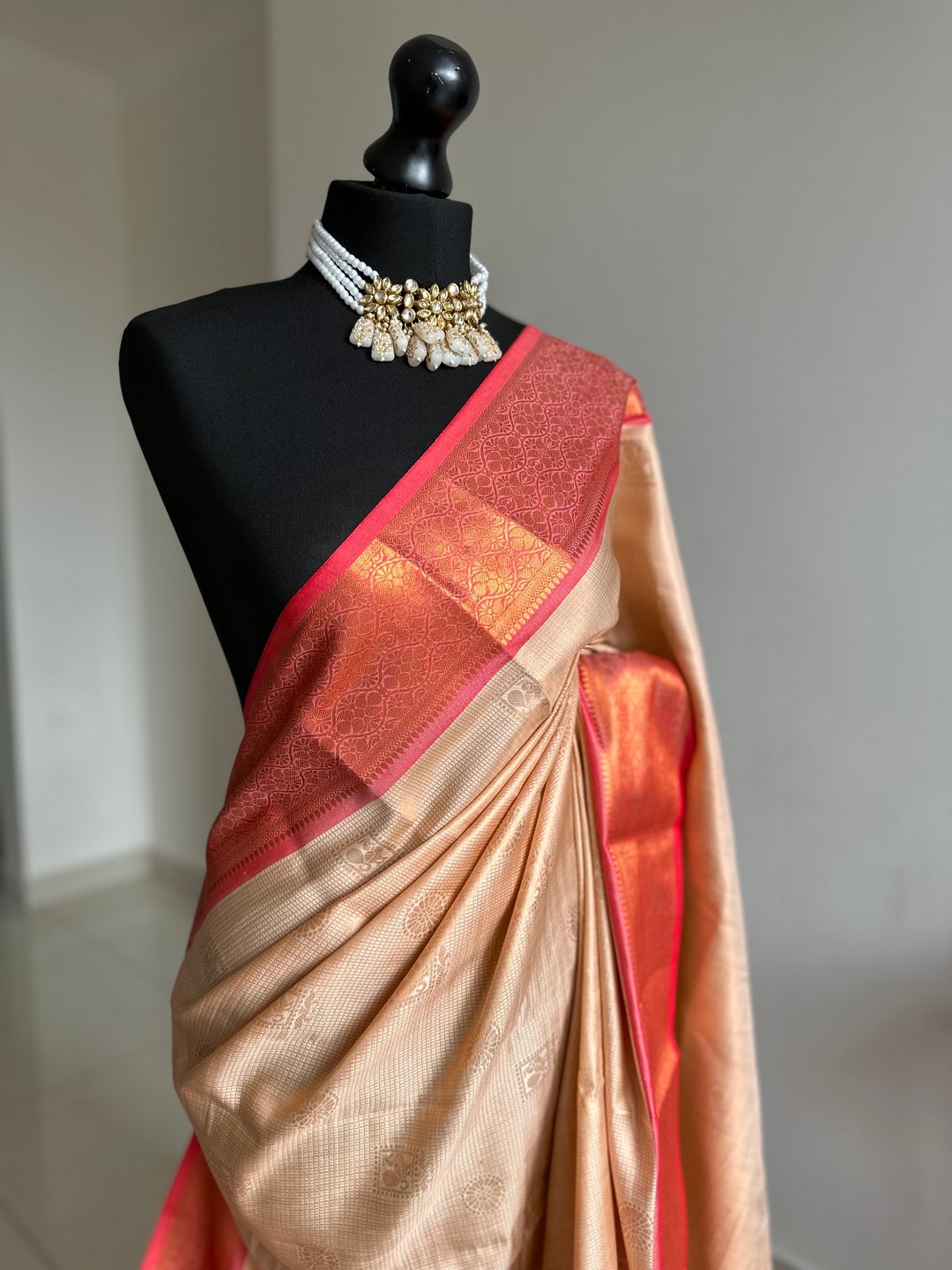 Cream Saree With Hues of Salmon Pink and Red. Authentic Traditional