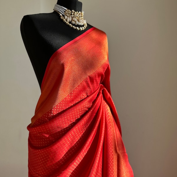 Chilli red soft silk saree with a copper border and all over sheen. The perfect saree for parties and all traditional events.