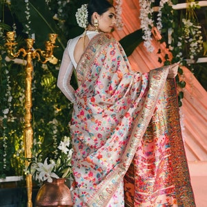 Gorgeous cream handloom silk multicoloured designer traditional saree with gold border weaving work all over.