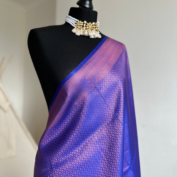 Royal blue soft silk saree with a copper border and all over sheen. The perfect saree for parties and all traditional events.Versatile saree