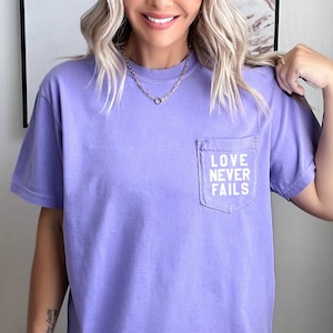 Love Never Fails Comfort colors Pocket Shirt | Christian Apparel, Faith Clothing, Christian T-Shirt, Christian Gift, Comfort Colors T-shirt