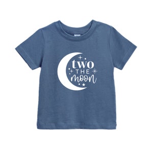 May include: A blue short-sleeved t-shirt with a white crescent moon graphic and the text "two the moon" on the front.