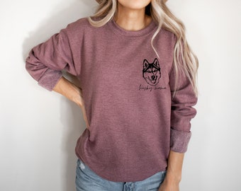 May include: A mauve sweatshirt with a black silhouette of a husky dog's head and the text "husky mama" printed on the front.