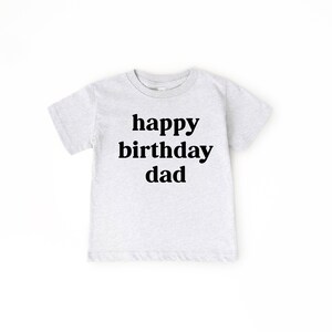 May include: A light grey t-shirt with the text "happy birthday dad" printed in black.
