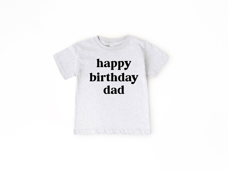 May include: A light grey t-shirt with the text "happy birthday dad" printed in black.