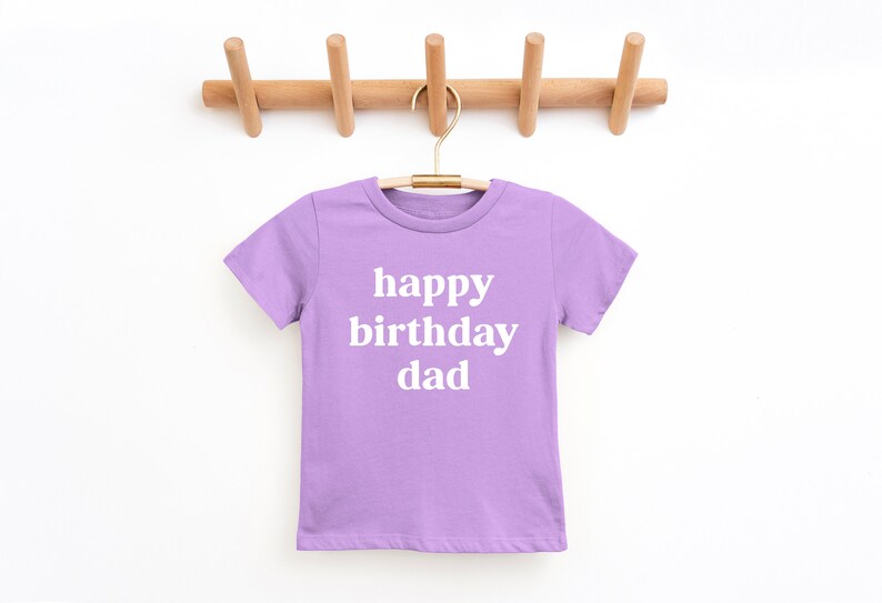 May include: A lavender t-shirt with the text "happy birthday dad" in white.