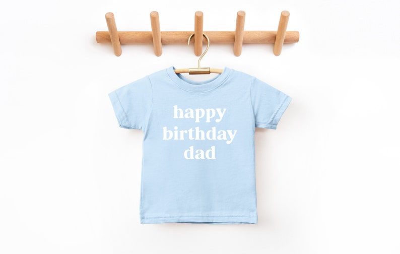 May include: A light blue t-shirt with the text "happy birthday dad" in white.
