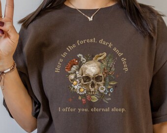May include: Brown oversized t-shirt with a skull and floral design. The text on the shirt reads "Here in the forest, dark and deep. I offer you, eternal sleep."