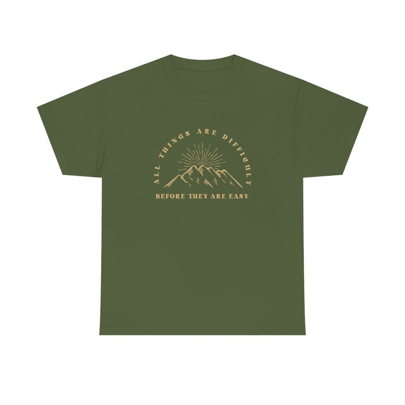 May include: Green t-shirt with a mountain range graphic and the text "All things are difficult before they are easy."