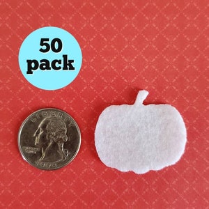 May include: A pack of 50 white felt pumpkin shapes. The pumpkins are about the size of a US quarter.