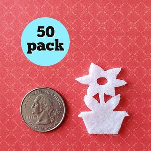 May include: A pack of 50 white felt flower pot shapes. The flower pot shapes are about the size of a US quarter.
