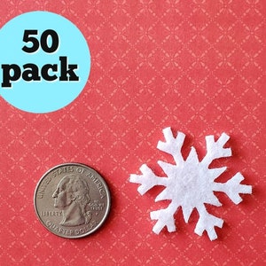 May include: A pack of 50 white felt snowflake shapes. The snowflakes are about the size of a US quarter.