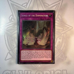 May include: A holographic trading card titled "SONGS OF THE DOMINATORS" with a purple border. The card features an illustration of a figure with wings in a fantasy setting. The card text describes its effects and activation conditions.