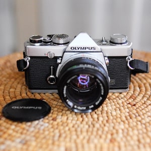 Olympus OM-1n analog 35mm film camera in near-mint condition! Cleaned, adjusted, tested, guaranteed