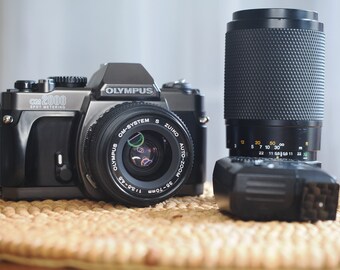 Olympus OM2000 35mm analog film camera with 35-70mm and 70-210mm lenses. Tested and working beautifully!