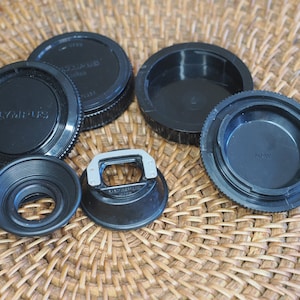 Olympus OM analog film camera accessories: eyecup, lens caps, hot shoe and others