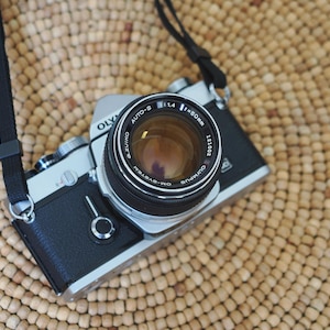 Olympus OM-1n analog 35mm film camera in excellent condition! Cleaned, adjusted, tested, guaranteed