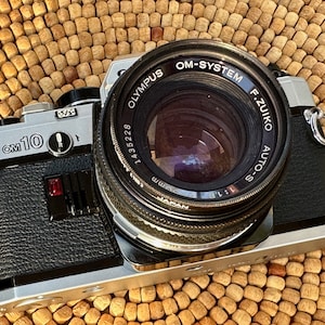Olympus OM10 35mm analog film camera in excellent condition! Cleaned, Calibrated, Tested and Guaranteed!