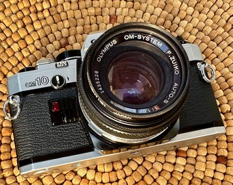 Olympus OM10 35mm analog film camera in excellent condition! Cleaned, Calibrated, Tested and Guaranteed!