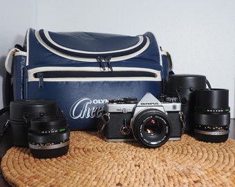 Olympus OM-2n 35mm analog film camera kit - 28mm, 50mm, 135mm lenses, all working perfectly and guaranteed!