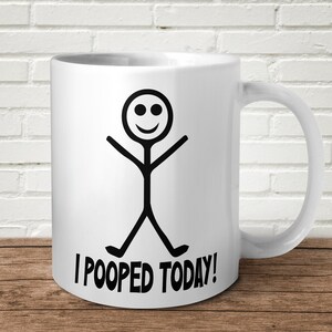 May include: White ceramic coffee mug with a black stick figure illustration and the text "I POOPED TODAY!" printed on the front.