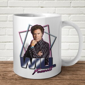 May include: White ceramic mug featuring a colourful graphic of Will Ferrell with the text "WILL Ferrell" in a retro style.