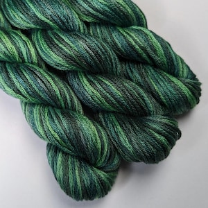 May include: Two skeins of green and black variegated embroidery floss.