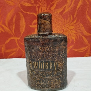 old Whiskey flask covered with embossed imitation leather