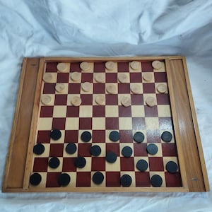 old wooden game board, game of little horses (hobby horses) and checkers with its pieces