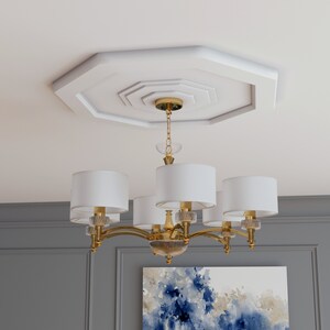 K&ouml;nnte beinhalten: Ein goldener Kronleuchter mit wei&szlig;en Stoffschirmen h&auml;ngt an einem dekorativen achteckigen Deckenmedaillon. Der Kronleuchter hat sechs Lichter und ein geschwungenes Design.