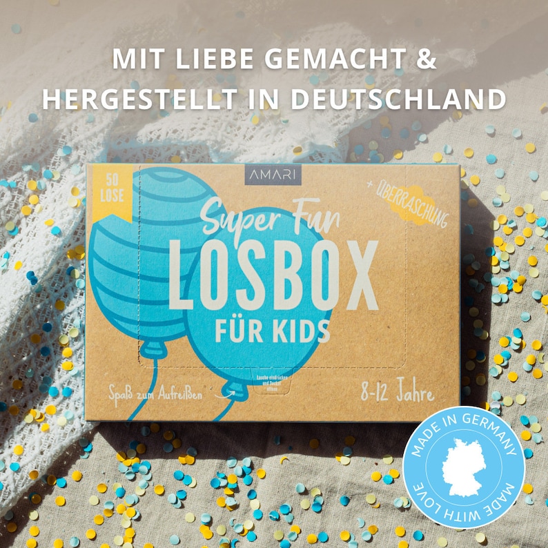 AMARI Kinder-Losbox, in Deutschland mit Liebe hergestellt und auf einem Tisch präsentiert – perfektes Geschenk für Kinder jeden Alters.