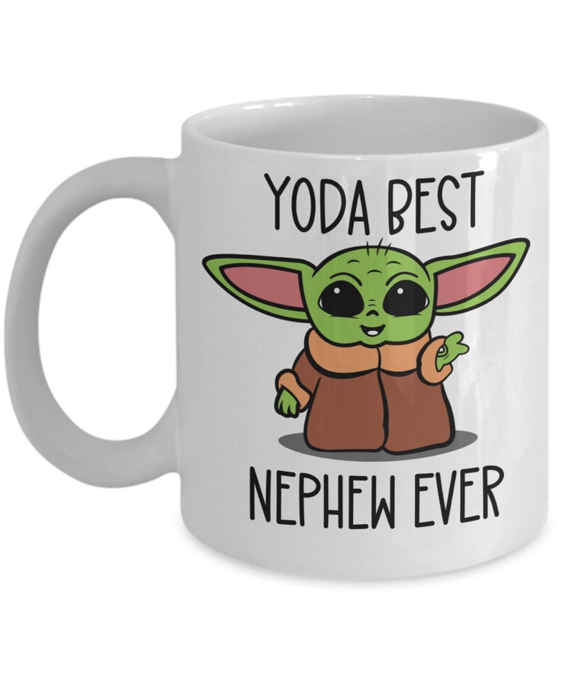 May include: White ceramic mug with a green cartoon character with big eyes and the text "Yoda Best Nephew Ever".