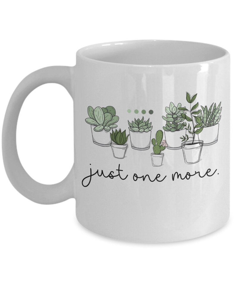 May include: White ceramic mug with a black outline of potted succulents and the text "just one more."