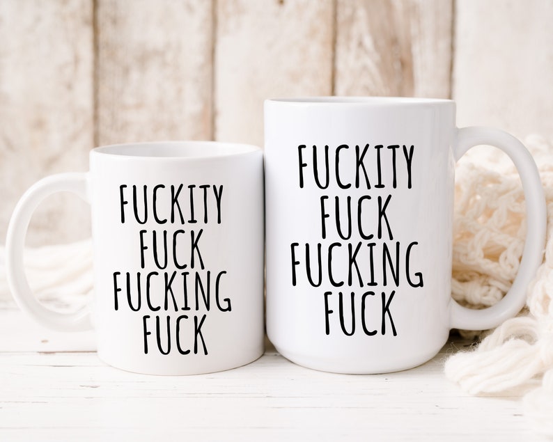 May include: Two white ceramic mugs with black text. The text on both mugs reads "F*ckity F*ck F*cking F*ck".