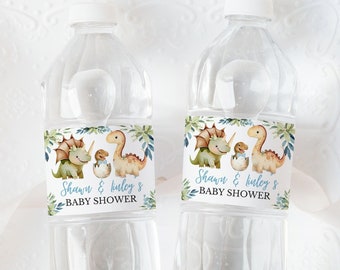 May include: Two clear plastic water bottles with labels that say "Shawn & Haley's Baby Shower" and feature a cartoon dinosaur design.