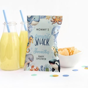 May include: A blue and white snack bag with a sea life theme. The bag has the text "Mommy's Favourite Snack" and "Samantha's Baby Shower".