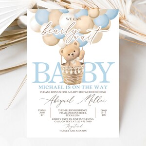 May include: A baby shower invitation with a blue and beige color scheme. The invitation features a teddy bear in a hot air balloon made of balloons. The text on the invitation reads "We can barely wait Baby Michael is on the way. Please join us for a baby shower honoring Abigail Miller. Friday June 27 From 2-5 pm. The Miller's Residence 17 Halloween Street, Texas, 1234. Kindly RSVP by June 15 to Fiona Call or text at 123 456 7890 Registered Target and Amazon."