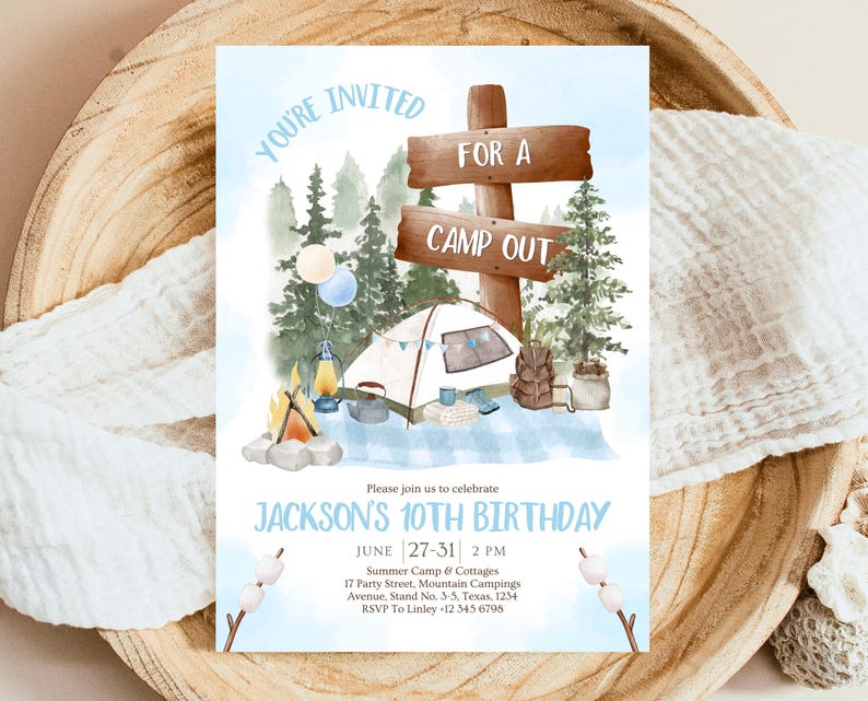May include: A blue and white invitation for a camp out themed birthday party. The invitation features a cartoon illustration of a tent, a campfire, and a sign that says "For a Camp Out". The text on the invitation reads "You're Invited" and "Jackson's 10th Birthday".