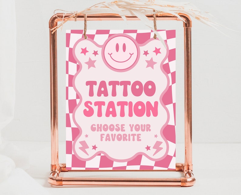 May include: Pink and white checkered sign with a pink cloud shape. The sign says "Tattoo Station" and "Choose your favorite".