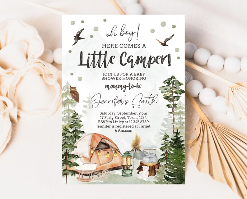 May include: A baby shower invitation with a woodland theme. The invitation features a watercolour illustration of a tent, a campfire, and a forest. The text on the invitation reads "oh boy! Here comes a Little Camper!" and includes the name "Jennifer's Smith".