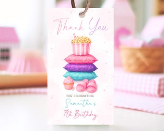 May include: A pink gift tag with a watercolour illustration. The tag features a stack of pillows, popcorn, a cupcake, and slippers. Text reads "Thank You" and "For Celebrating Samantha's 7th Birthday."