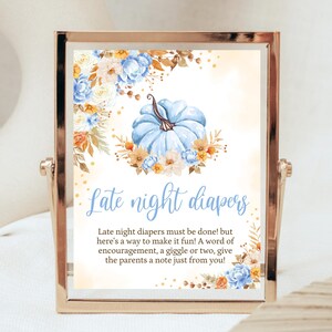 May include: A printable sign with a blue and white pumpkin and floral design. The text reads "Late night diapers. Late night diapers must be done! but here's a way to make it fun! A word of encouragement, a giggle or two, give the parents a note just from you!"